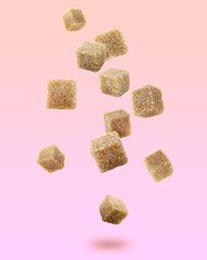 Brown cane sugar cubes falling on color gradient background