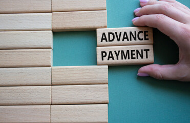 Advance Payment symbol. Concept words Advance Payment on wooden blocks. Businessman hand. Beautiful...