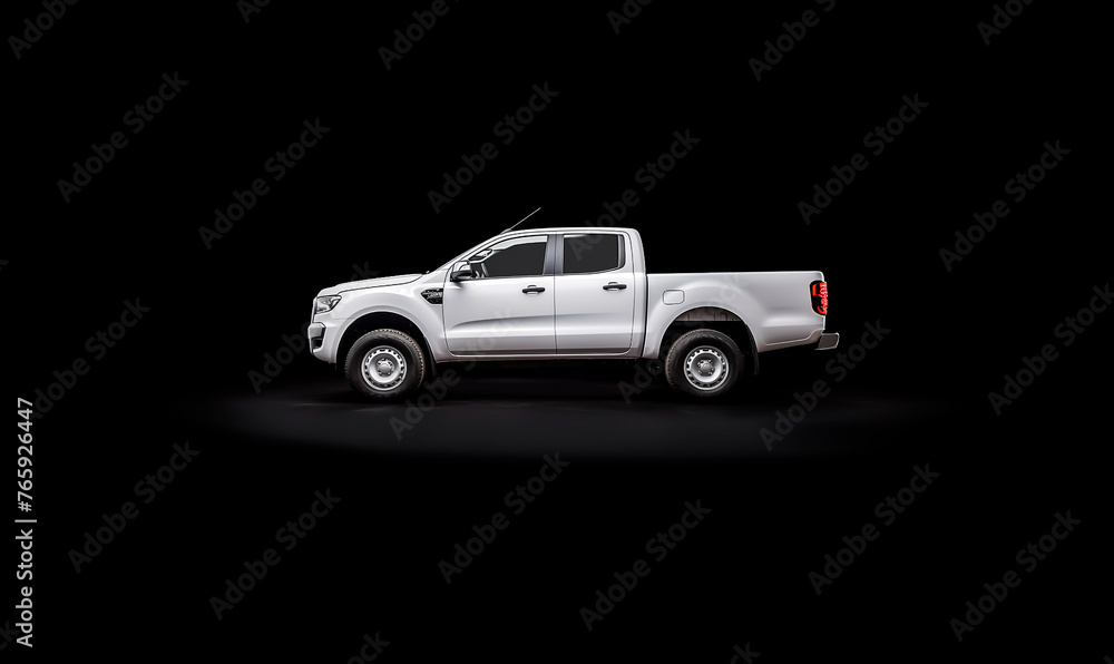 Wall mural a white pickup truck is parked in front of a black background