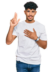 Young arab man wearing casual white t shirt smiling swearing with hand on chest and fingers up,...