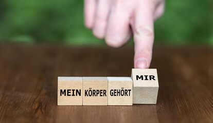 Wooden cubes form the German expression 'mein Koerper gehoert mir' (my body belongs to me). - obrazy, fototapety, plakaty