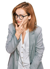 Young caucasian woman wearing business style and glasses pointing to the eye watching you gesture, suspicious expression