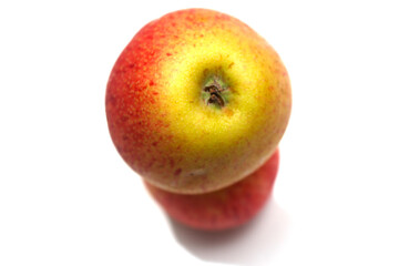 one apple over another. red fruit with selective focus. red and yellow natural food.
