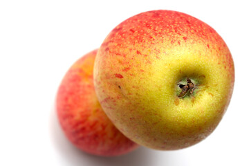 one apple over another. red fruit with selective focus. red and yellow natural food.