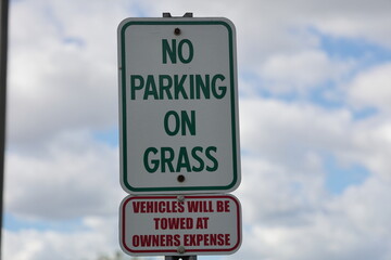 No parking on the grass sign