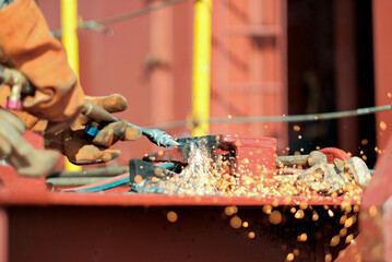 Hot Work Permit Risk Assessment. Certified Welder Man Cutting Metal Container Lashing Bar Bracket...