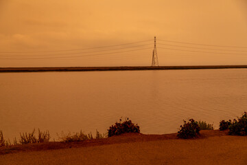 California Westpoint Slough on San Francisco Bay, California; Orange Smoke Filled Skies from Nearby Out of Control Wildfires Caused by Drought and Climate Change - 765935282