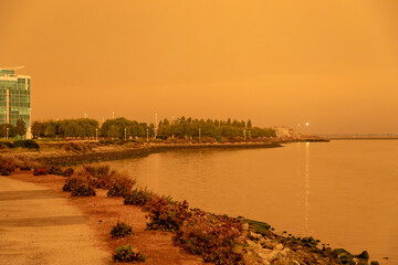 Dark Orange Smoky Skies at the Redwood City California Westpoint Slough from Nearby Out of Control Wildfires Caused by Drought and Climate Change - 765935437