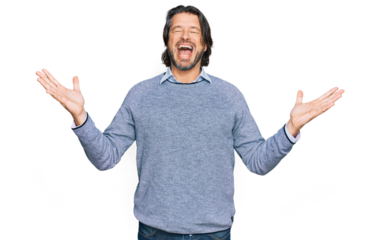 Middle age handsome man wearing casual clothes celebrating mad and crazy for success with arms raised and closed eyes screaming excited. winner concept