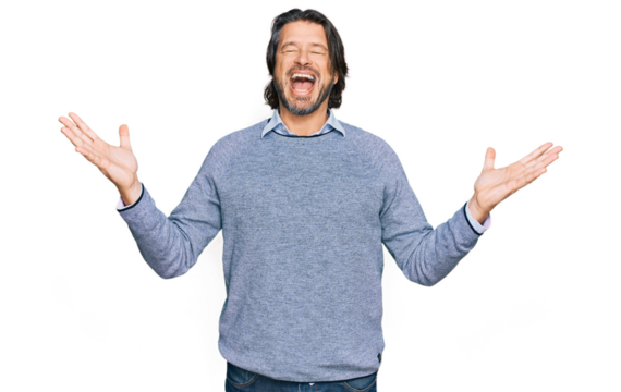 Middle age handsome man wearing casual clothes celebrating mad and crazy for success with arms raised and closed eyes screaming excited. winner concept