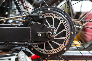 Fototapeta na wymiar Electric bike rear hydraulic disc brake close up