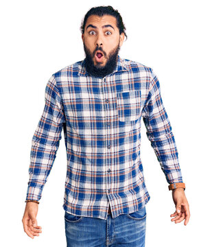 Young arab man wearing casual clothes afraid and shocked with surprise expression, fear and excited face.