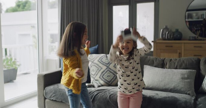 Winner, children and play video game in home living room together for competition victory on sofa. Tv technology, girls and celebration on controller, entertainment and excited family of sisters hug