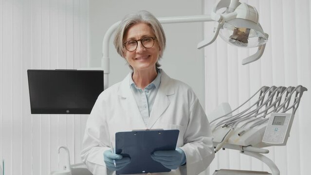 Female Dentist Preparing for Patient: Smiling Medium Shot to Close-up