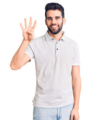 Young handsome man with beard wearing casual polo showing and pointing up with fingers number four while smiling confident and happy.