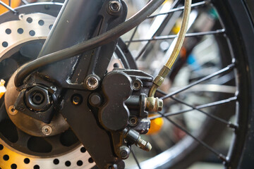 Electric bike front hydraulic disc brake system close up with lens flare
