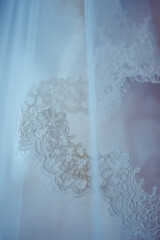Closeup detail of bridal veil embroidery on tulle silk material