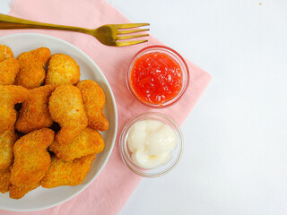 Delicious chicken nuggets in a plate, isolated white background