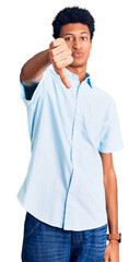 Fototapeta premium Young african american man wearing casual clothes looking unhappy and angry showing rejection and negative with thumbs down gesture. bad expression.