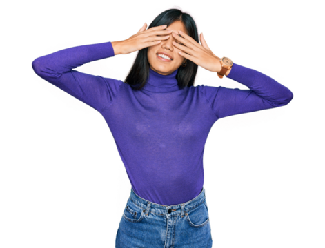 Beautiful young asian woman wearing casual clothes covering eyes with hands smiling cheerful and funny. blind concept.