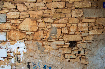 stone wall of abandoned house,background