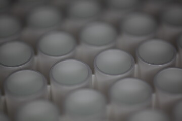 Close-up of a white plastic 96-well plate used for luminescence measurement in biology - shallow...