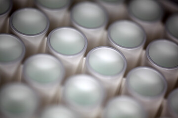 Close-up of a white plastic 96-well plate used for luminescence measurement in biology - shallow...