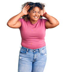 Young african american plus size woman wearing casual clothes trying to hear both hands on ear gesture, curious for gossip. hearing problem, deaf