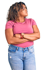 Young african american plus size woman wearing casual clothes looking to the side with arms crossed...
