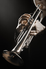 Trumpet player hands playing brass instrument - 765958267