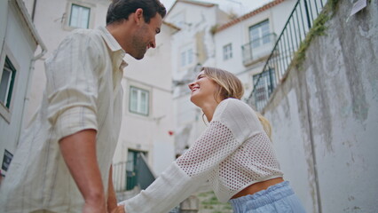 Embracing spouses enjoying love mediterranean town closeup. Man swirling woman