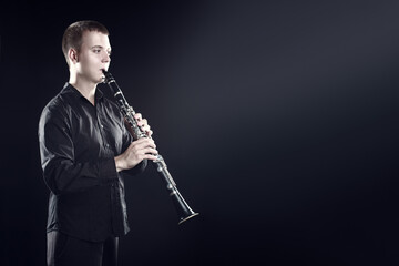 Clarinet player classical musician portrait. Clarinetist playing woodwind instrument - 765961853