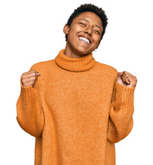 Young african american woman wearing casual clothes very happy and excited doing winner gesture...