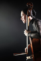 Cello player cellist playing violoncello in profile - 765964033
