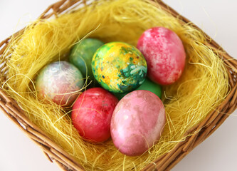 Colorful Easter eggs. Traditional Easter food and decoration in the basket.