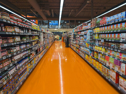Rows of shelves at Loblaws grocery store stacked with food products, Toronto Canada.	