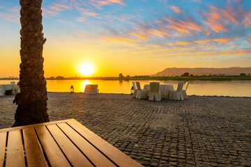 Sunset view from the banks of the Nile River looking across towards the west bank Theban cliffs, in Luxor, Egypt.