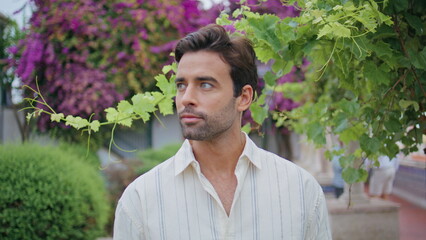 Romantic man looking distance near grape bush closeup. Latin macho portrait