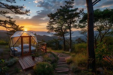 Alpine Dawn at Mountain Glamping Retreat. Glamping retreat catches first light of dawn atop mountain clouds. Elegantly designed glass cabin on hilltop is enveloped by golden light