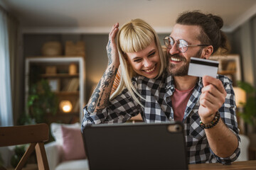 adult happy couple man and woman shopping online hold credit card