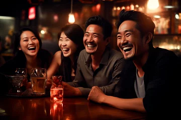 Foto op Canvas Young men of Asian appearance, partying and drinking at a bar, merrily discussing an interesting topic © EUDPic