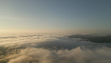 Aerial view of foggy mountain valley on an early Spring morning