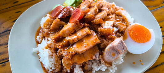 Red pork and crispy pork on rice, food in Thailand
