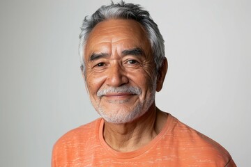 A man with a white beard and gray hair is smiling for the camera