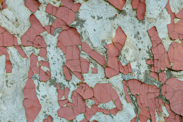 The wall is covered in red paint and has a lot of cracks