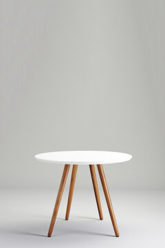 A modern table with wooden legs and a white top.