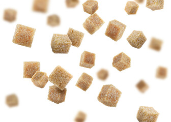 Brown cane sugar cubes falling on white background