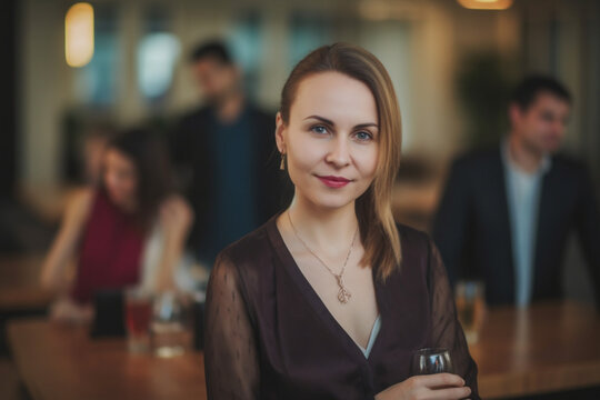A portrait of a cheerful businesswoman during a business party gathering