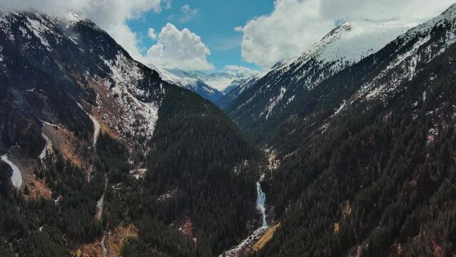 Aerial view of mountains and Krimml Waterfalls on sunny day. High Tauern National Park, Austrian Alps, Austria, 4k