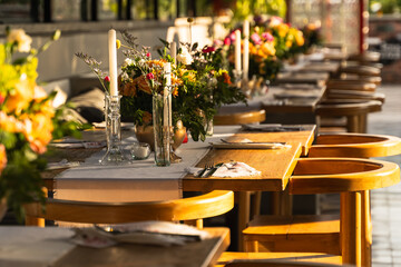 Beautiful and elegant table setting on a hotel rooftop. Flowers, sunset and elegance.